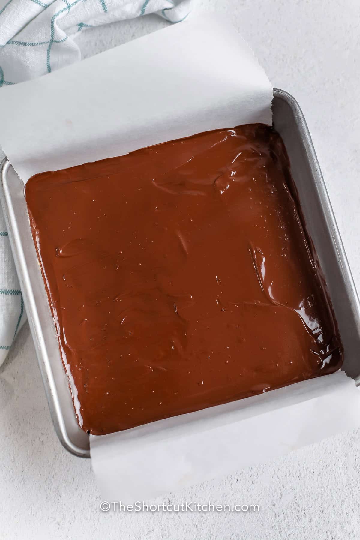 Rich, creamy, and topped with smooth chocolate, this peanut butter bars recipe comes together with everyday ingredients and chills into perfectly sliceable dessert bars. They're ideal for bake sales, potlucks, and freezer-friendly treats. Pin it now. #theshortcutkitchen Peanut Butter Bars before cooling