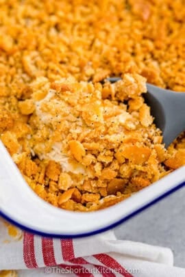 taking Chicken Poppyseed Casserole out of the casserole dish
