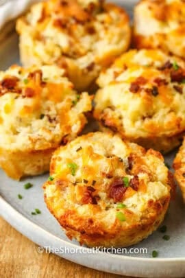 loaded mashed potato cups on a white plate.