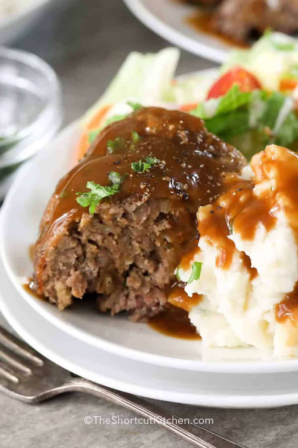 stove top stuffing with gravy and mashed potatoes on a white plate.