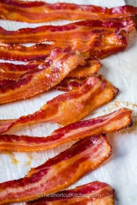 closeup of brown sugar bacon draining on paper towels.