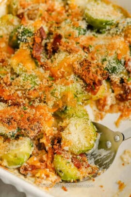 Brussel Sprout Casserole in the casserole dish with a spoon.