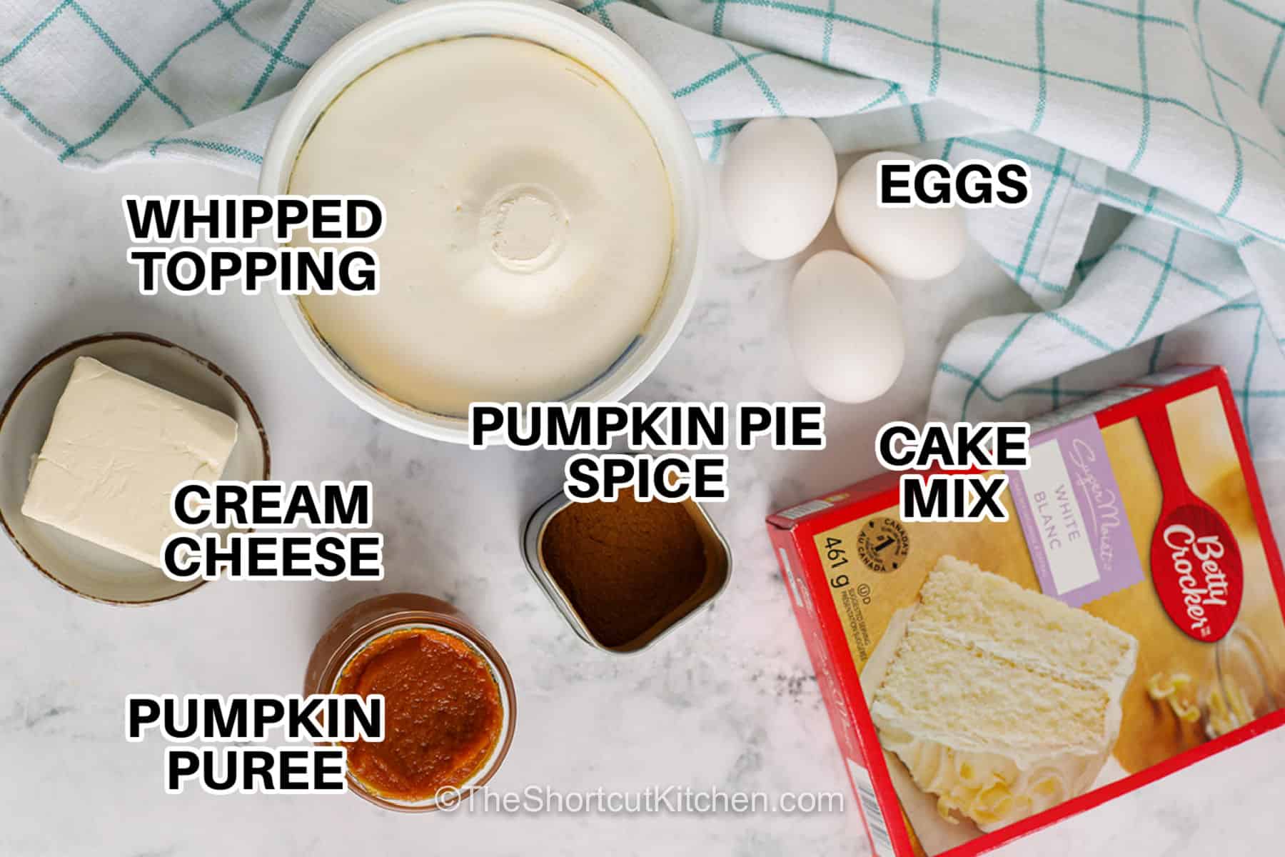 Pumpkin roll cake is easier to make with a simple cake mix shortcut. Canned pumpkin and pumpkin pie spice create a soft, warmly spiced cake that is rolled around a fluffy cream cheese and whipped topping filling. Bake it in a jelly-roll pan, roll while warm, then chill for beautiful spiral slices. Make this easy pumpkin roll cake for Thanksgiving, fall parties, or a cozy dessert night. Save this recipe for fall baking. #theshortcutkitchen whipped topping , pumpkin pie spice , cream cheese , pumpkin puree , eggs and cake mix with labels to make Pumpkin Roll Cake.