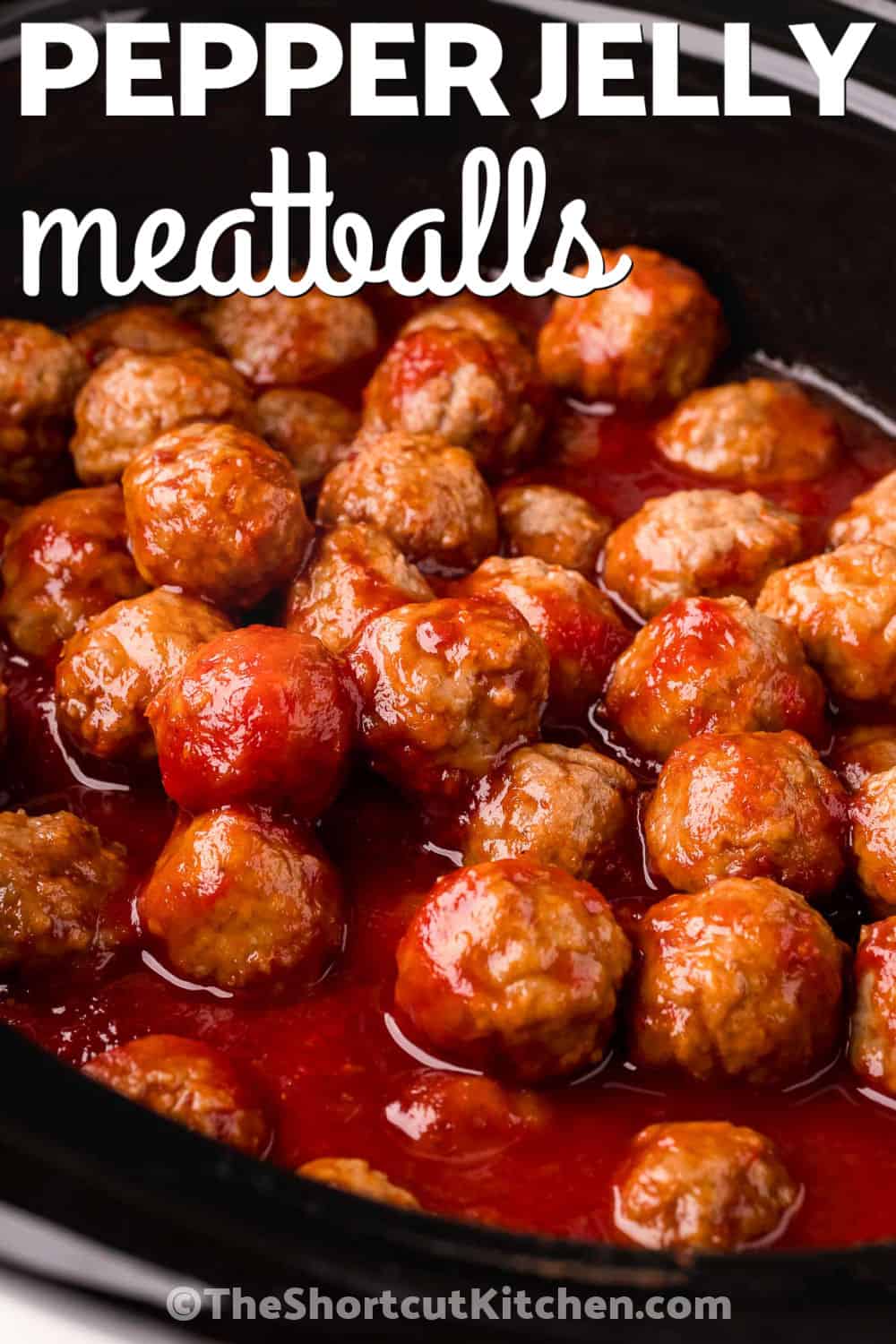 Pepper jelly meatballs are a simple crockpot appetizer with a delicious sweet and spicy sauce. Frozen meatballs simmer with raspberry jam, chili sauce, and hot pepper jelly for a bite that is rich, tangy, and full of flavor. They are easy to keep warm for parties, game day, holidays, or casual gatherings. Add these crowd-pleasing meatballs to your next appetizer spread and watch them disappear. Try them today and serve up an easy favorite. #theshortcutkitchen slow cooker with Pepper Jelly Meatballs and a title.