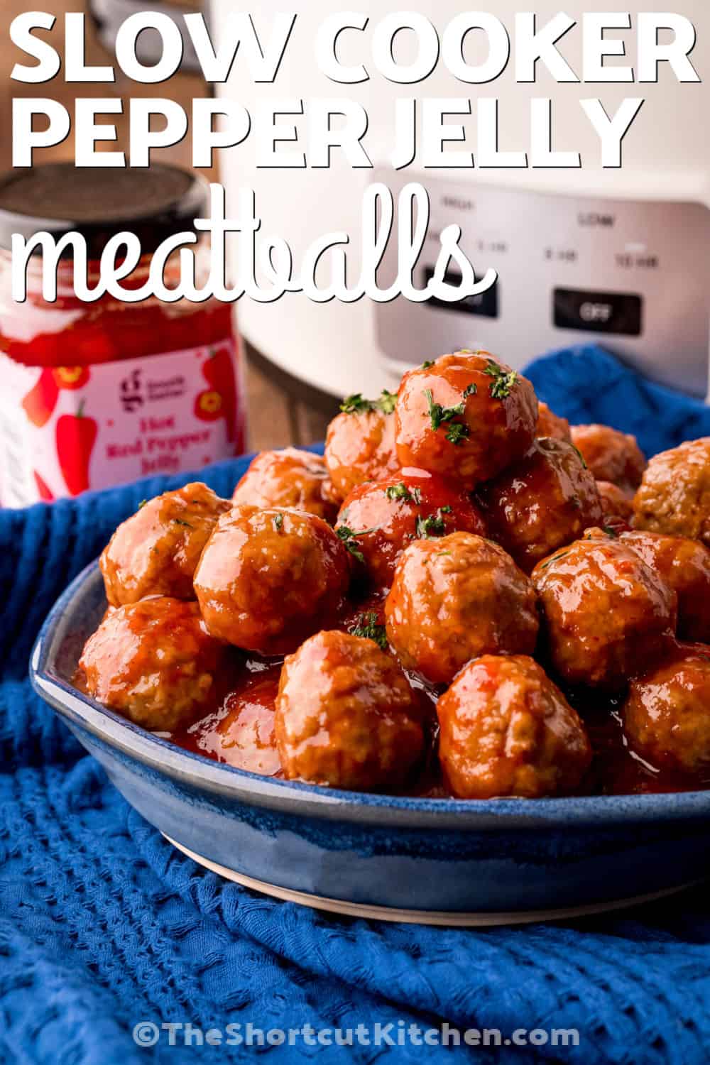 These pepper jelly meatballs bring sweet, spicy, and tangy flavor to your next gathering. The slow cooker combines tender meatballs with raspberry jam, chili sauce, and red pepper jelly for a flavorful sauce that coats every bite. This easy appetizer is perfect for parties, game day, or holiday entertaining. Keep them warm in the crockpot and let guests help themselves. Add this simple crowd-pleaser to your menu and enjoy every bite. #theshortcutkitchen plated slow cooker Pepper Jelly Meatballs with writing.