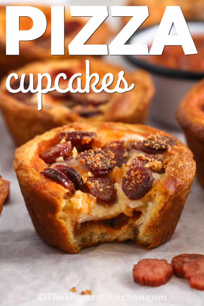 close up of Pizza Cupcakes with a bite taken out of one with a title.