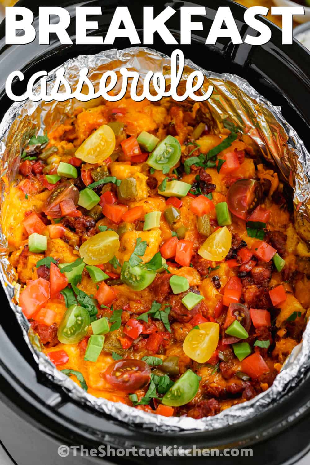 Make Slow Cooker breakfast strata when you need a savory breakfast that can feed a hungry family or brunch crowd. French bread absorbs a rich egg and half-and-half custard while chorizo, peppers, cumin, chili powder, and sharp cheddar add plenty of flavor. This easy slow cooker breakfast casserole also keeps valuable oven space free for other dishes. Pin this cozy breakfast recipe for later. #theshortcutkitchen slow cooker breakfast strata in a slow cooker with writing.