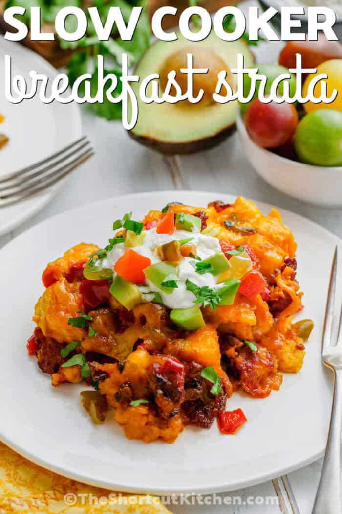 slow cooker breakfast strata serving on a plate with writing.