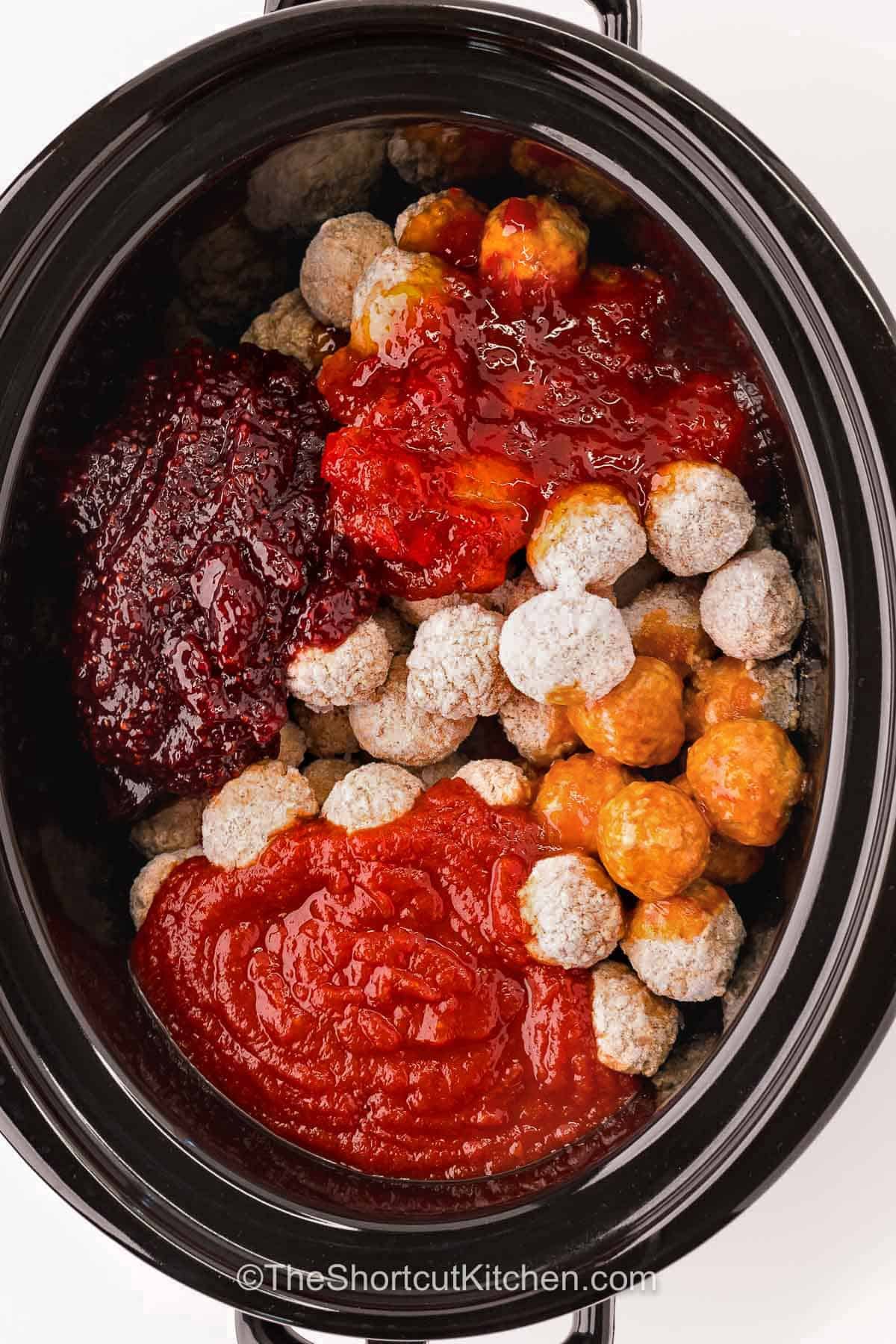 Crowd-pleasing pepper jelly meatballs are packed with sweet, tangy, and spicy flavor. This easy crockpot appetizer combines frozen meatballs with raspberry jam, chili sauce, and hot pepper jelly for a sauce that is hard to resist. They are perfect for holiday parties, potlucks, game day, or any gathering where you need an easy snack. Keep them warm in the slow cooker and let everyone dig in. Add this simple recipe to your menu and give it a try. #theshortcutkitchen adding ingredients together in slow cooker to make Pepper Jelly Meatballs.