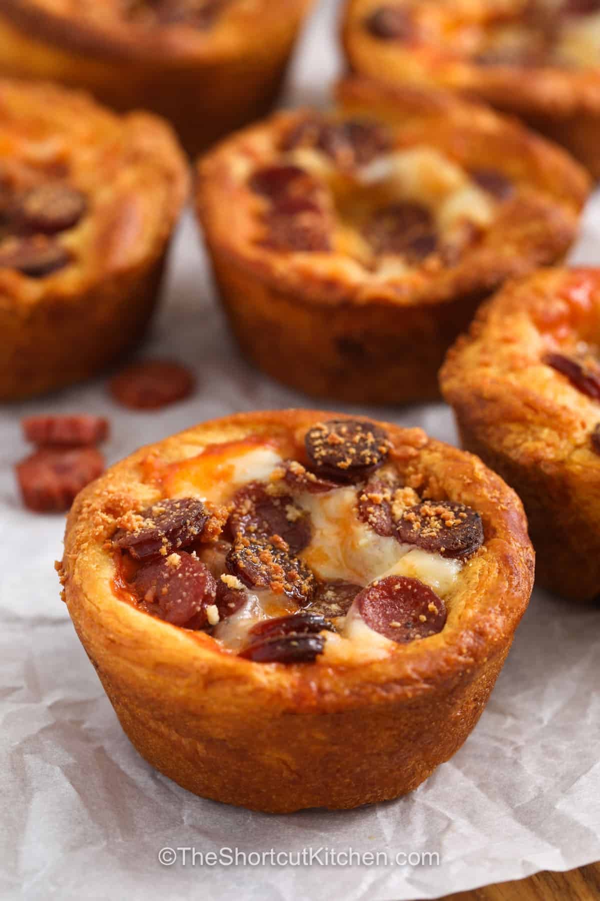 Looking for pizza cupcakes that are easy to love? This muffin tin recipe combines flaky crescent dough with pizza sauce, mozzarella, pepperoni, and Parmesan for a tasty bite with classic pizza flavor. The individual portions are perfect for parties, family snacks, or casual lunches. You can swap in your favorite toppings to make each batch just the way you like it. Try these fun pizza cupcakes today. #theshortcutkitchen pepperoni Pizza Cupcakes.